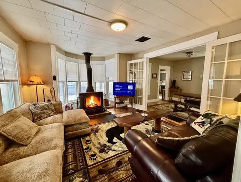 Living room with wood-burning stove and television