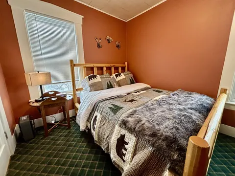 Queen bedroom with warm orange walls